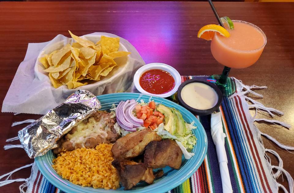 Carnitas plate with rice, beans, and chips
