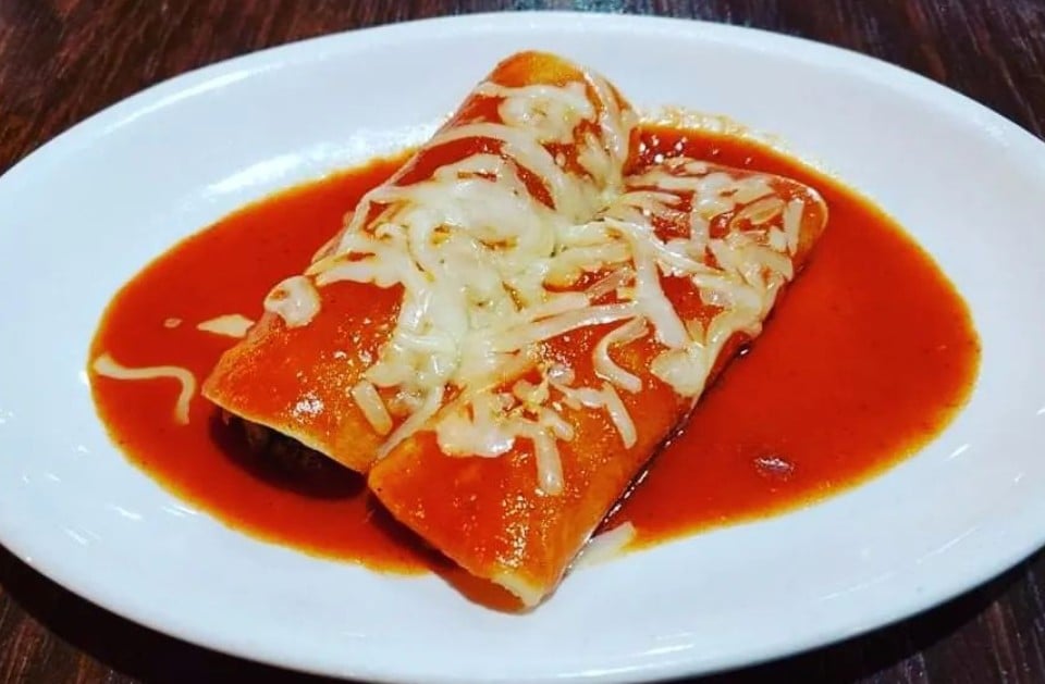 Cheese-topped enchiladas in red sauce